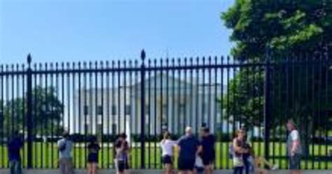 metal fence white house|white house blocked off.